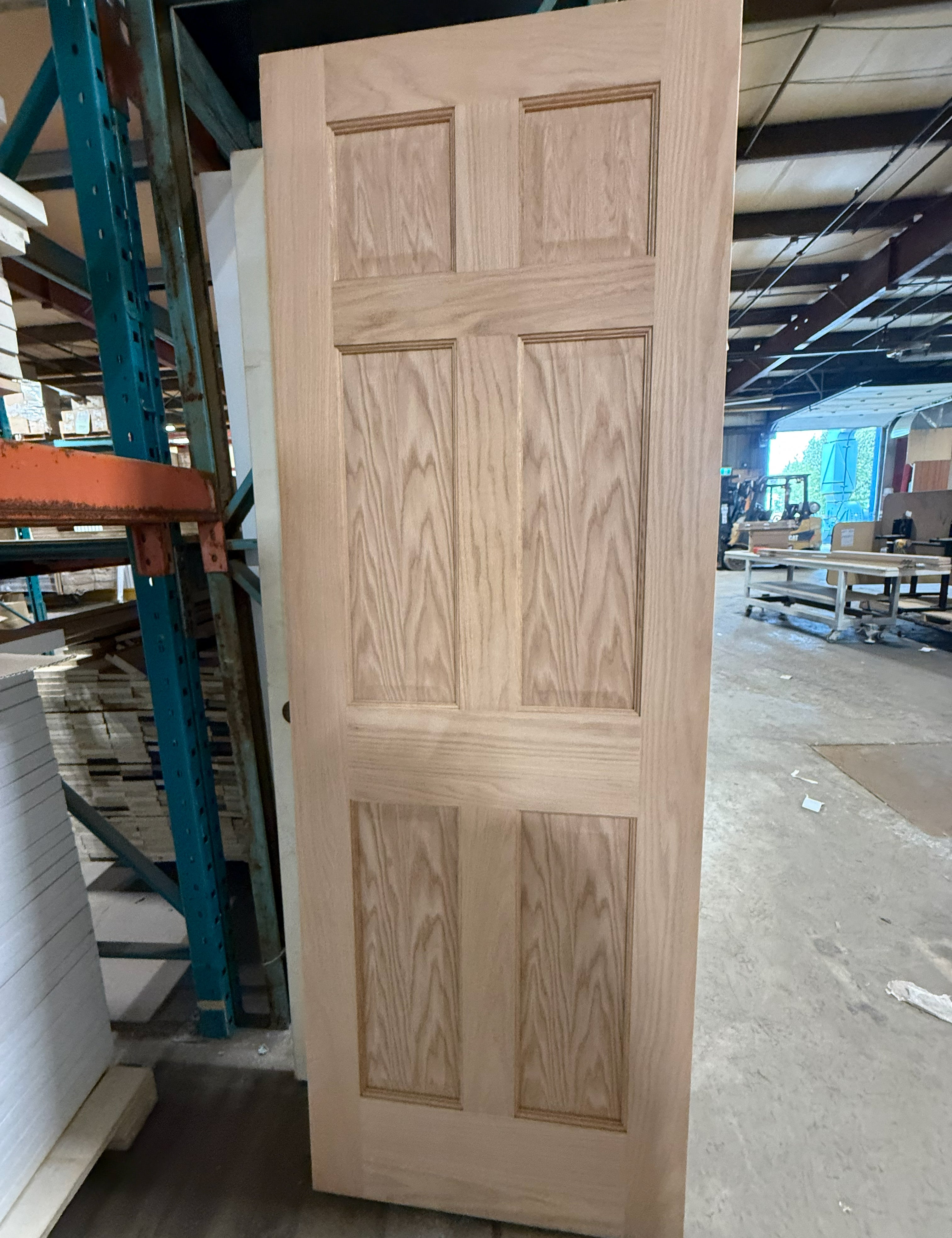 Unfinished oak six panel interior door shown full height, raw unstained oak face with no stain or clear coat.