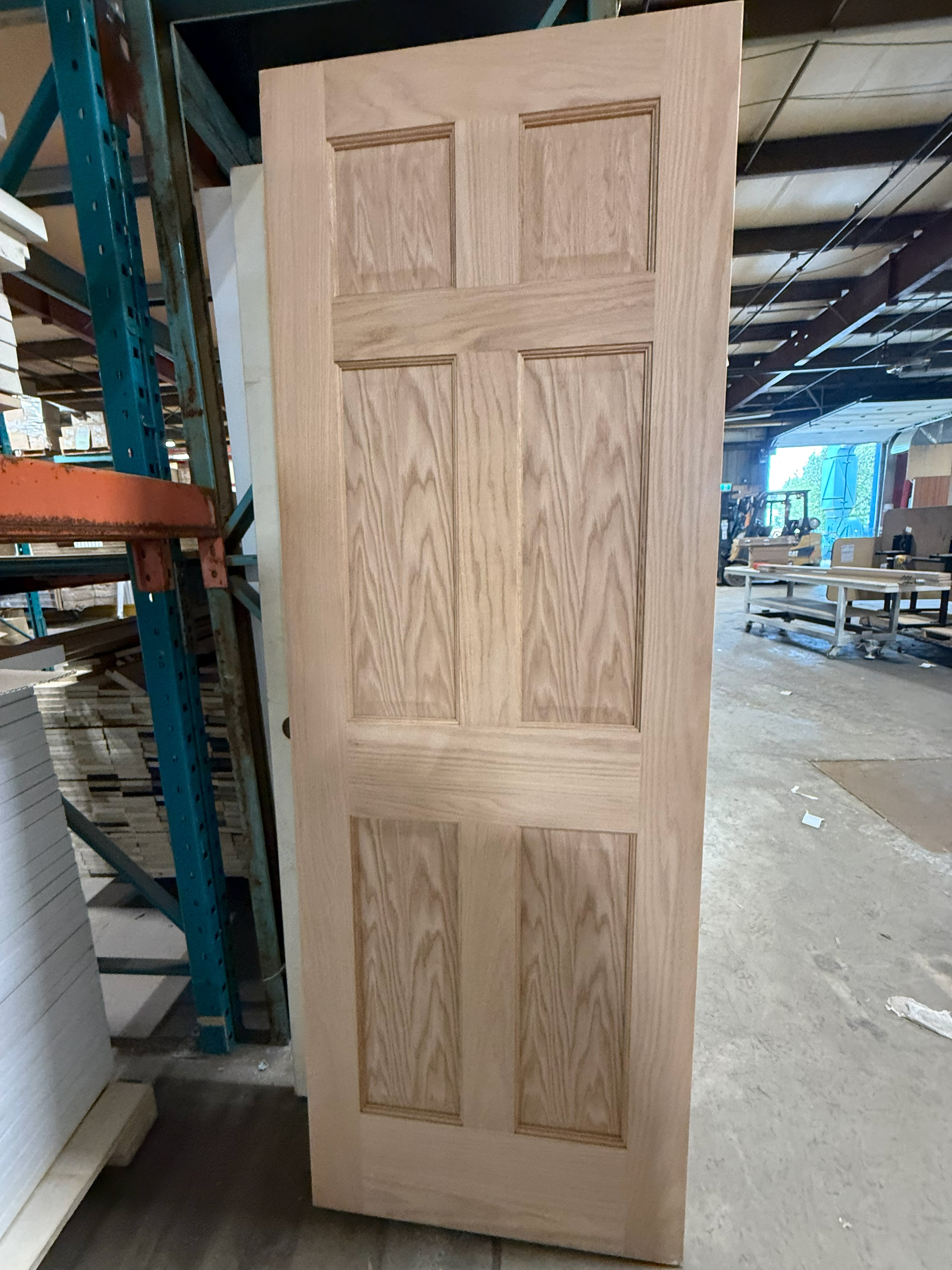 Unfinished oak six panel interior door shown full height, raw unstained oak face with no stain or clear coat.