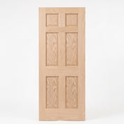 Unfinished oak 6 panel interior door, two small raised panels across the top and two tall raised panels in the middle and at the bottom.
