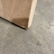 Close up of the bottom corner of the oak six panel door, showing the small chip where a piece of the corner is missing.